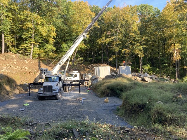 Crane setting Superior Walls foundation sections